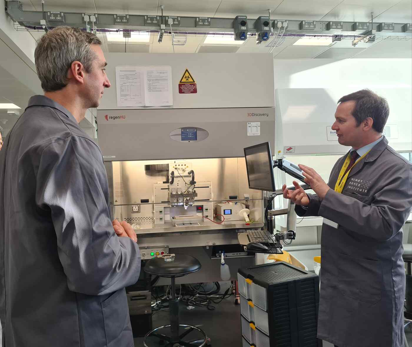 Chris Green MP on the right speaking to Dr Ian Wimpenny on the left in the bioprinting lab.