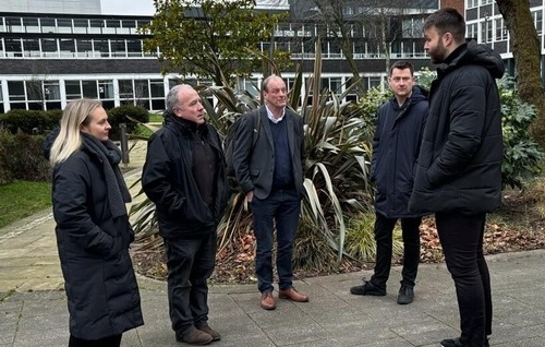 Mike Kane MP with several academics standing outside of the University of Manchester.