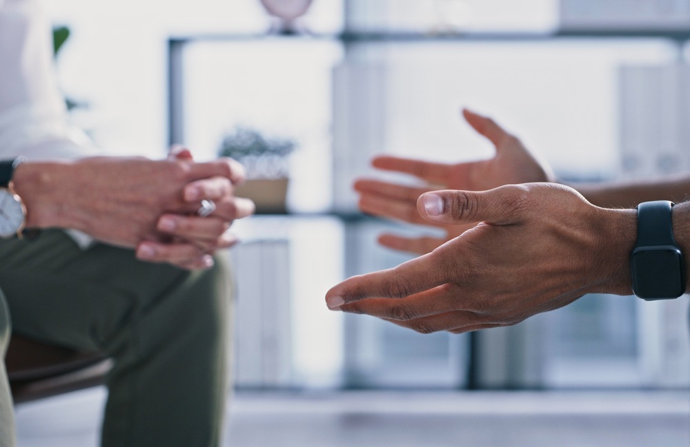Hands of two people talking