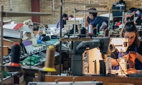 People working in a crowded textiles factory