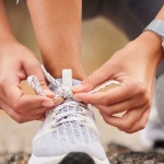 a women tying her shoelace