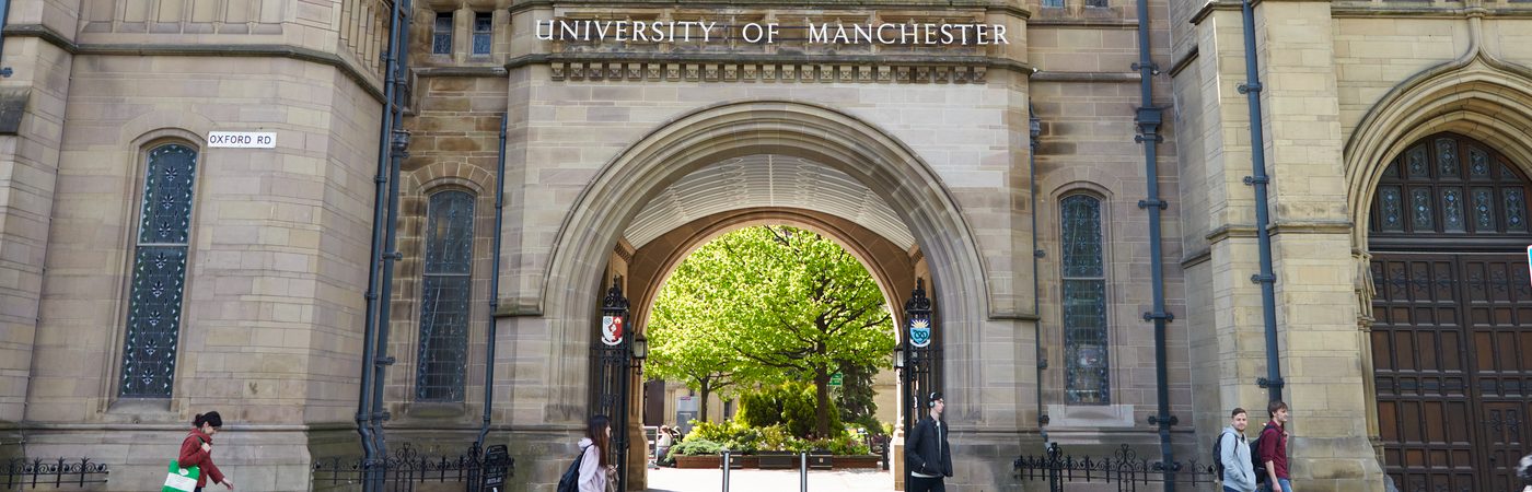 Photo of the Whitworth Arch at the University of Manchester with people walking past it