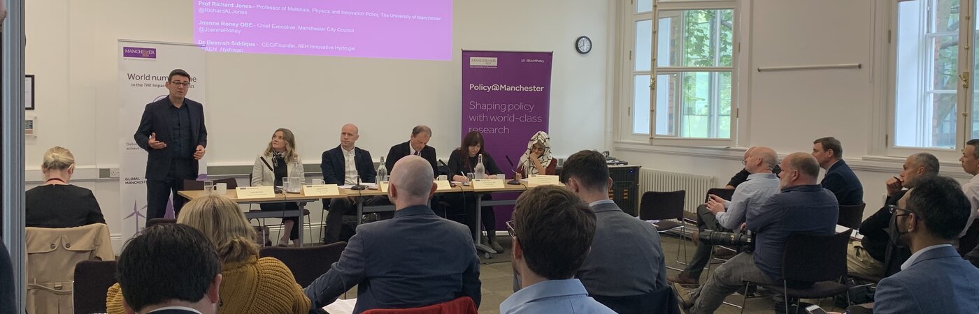 Policy@Manchester panel event with panellists and banners in the background